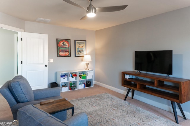 living room featuring ceiling fan and light carpet