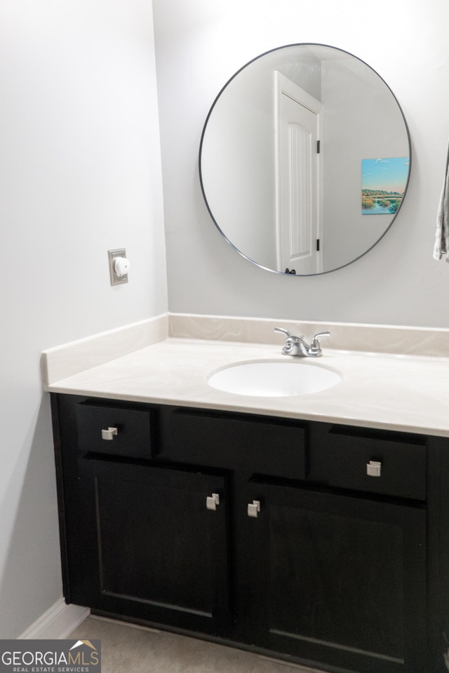 bathroom with tile patterned floors and vanity