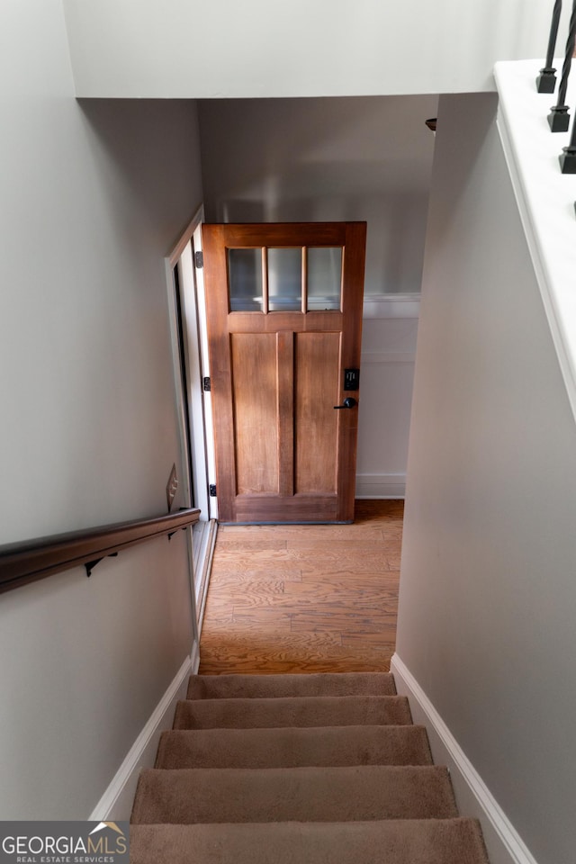 staircase featuring hardwood / wood-style flooring