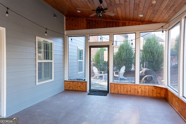 unfurnished sunroom with lofted ceiling, ceiling fan, and wooden ceiling