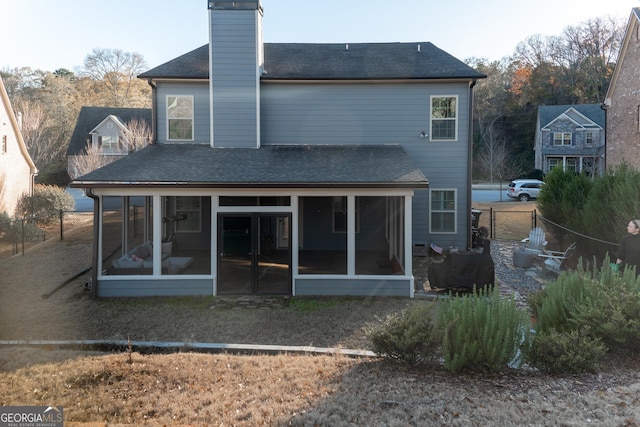 back of house featuring a sunroom