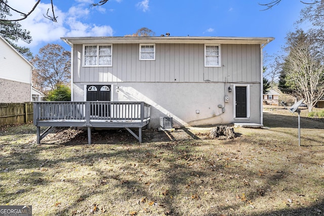 rear view of house featuring a deck, a lawn, and central air condition unit