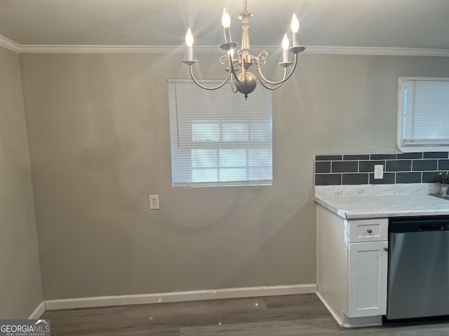 kitchen featuring white cabinets, stainless steel dishwasher, decorative backsplash, a notable chandelier, and dark hardwood / wood-style flooring