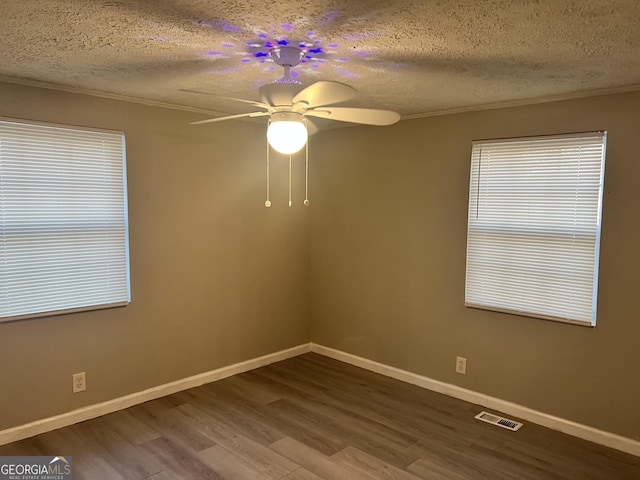 unfurnished room featuring hardwood / wood-style floors, a textured ceiling, ceiling fan, and ornamental molding