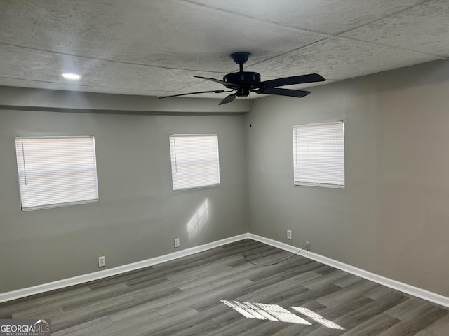 spare room with wood-type flooring and ceiling fan