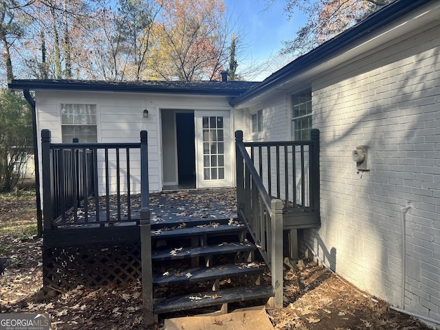 view of exterior entry with a wooden deck