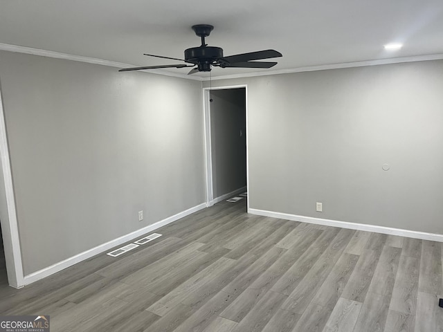 spare room with crown molding, ceiling fan, and light wood-type flooring