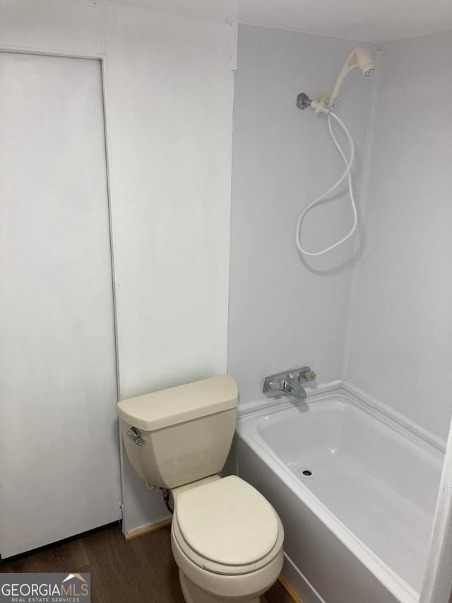 bathroom with hardwood / wood-style floors and toilet