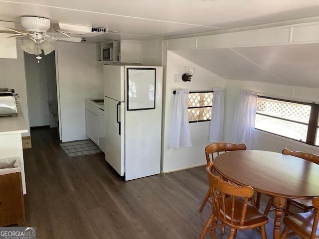 dining area featuring ceiling fan, sink, and dark wood-type flooring