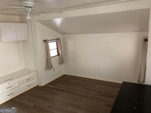 additional living space featuring ceiling fan, dark wood-type flooring, and vaulted ceiling