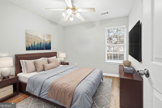 bedroom featuring hardwood / wood-style flooring and ceiling fan