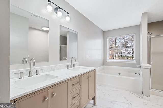 bathroom with vanity and shower with separate bathtub