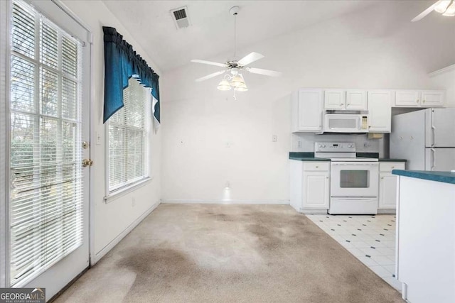 kitchen with white cabinetry, white appliances, light carpet, and vaulted ceiling