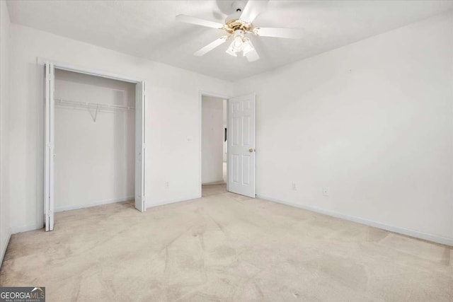 unfurnished bedroom with ceiling fan, light carpet, and a closet