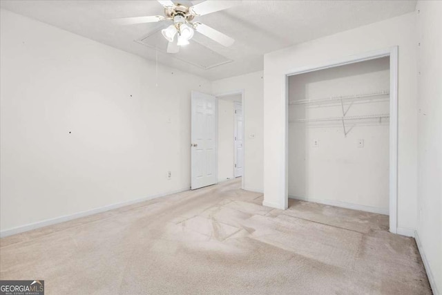 unfurnished bedroom with ceiling fan, light colored carpet, and a closet