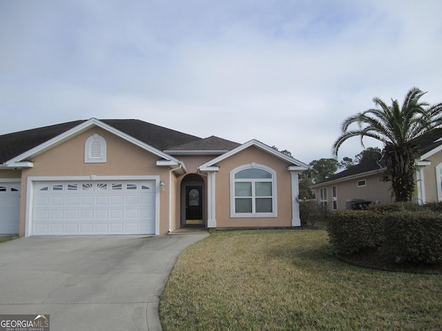 single story home with a garage and a front lawn