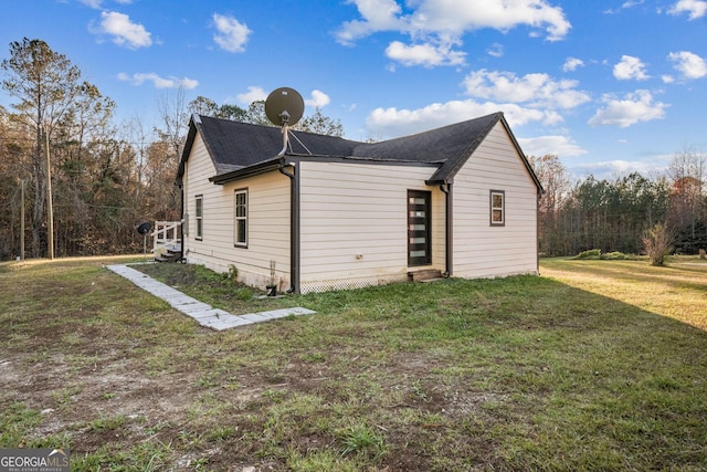 view of side of property with a lawn