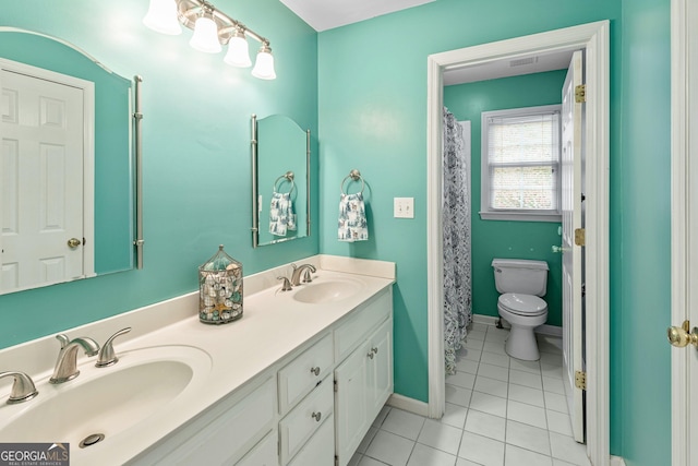 bathroom featuring vanity, a shower with curtain, tile patterned floors, and toilet