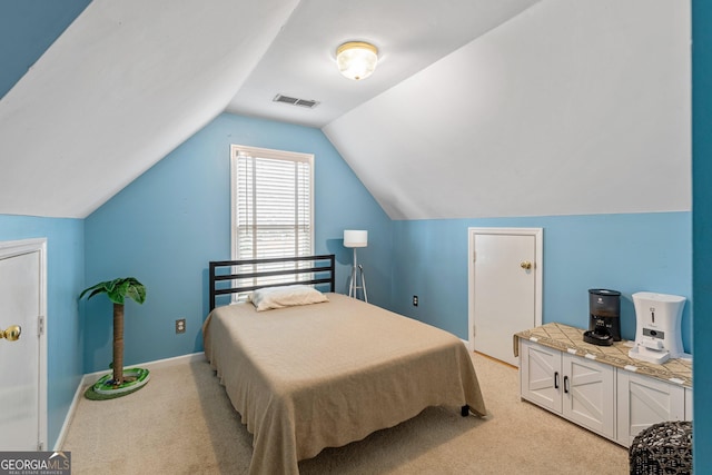 carpeted bedroom with lofted ceiling