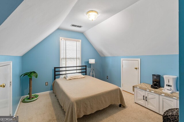 bedroom featuring visible vents, baseboards, a raised ceiling, and wood finished floors