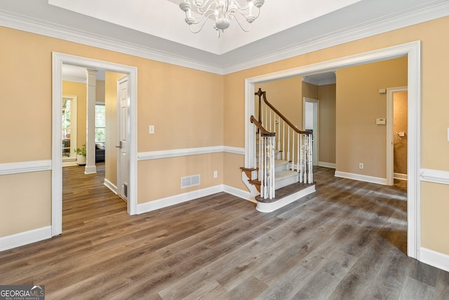 interior space featuring crown molding, dark wood-type flooring, and an inviting chandelier