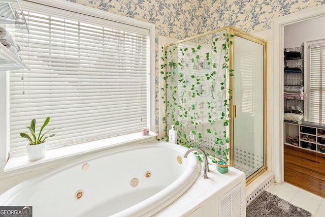 bathroom featuring a tub with jets, a stall shower, tile patterned flooring, and wallpapered walls