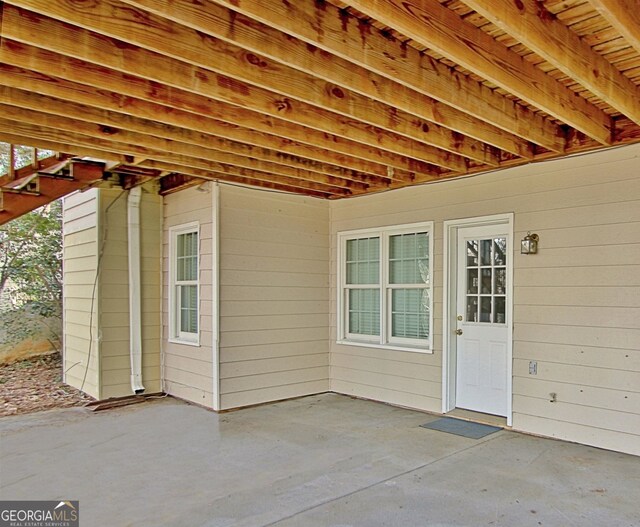 office area with built in features, visible vents, baseboards, and wood finished floors