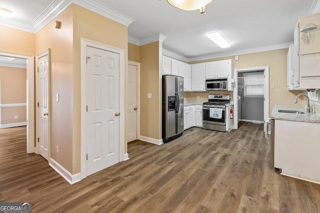 kitchen with sink, crown molding, dark wood-type flooring, appliances with stainless steel finishes, and white cabinets