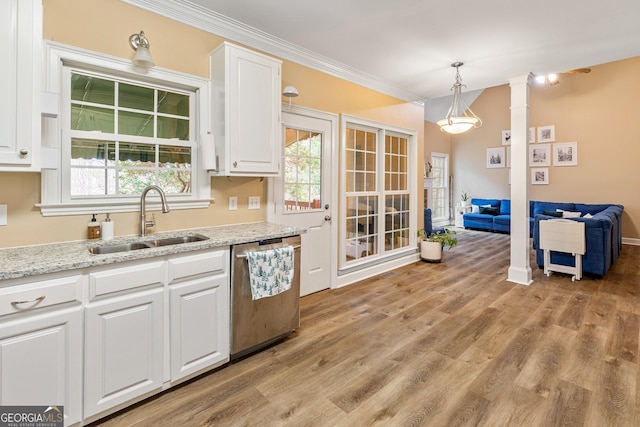 kitchen featuring sink, hanging light fixtures, dishwasher, decorative columns, and white cabinets