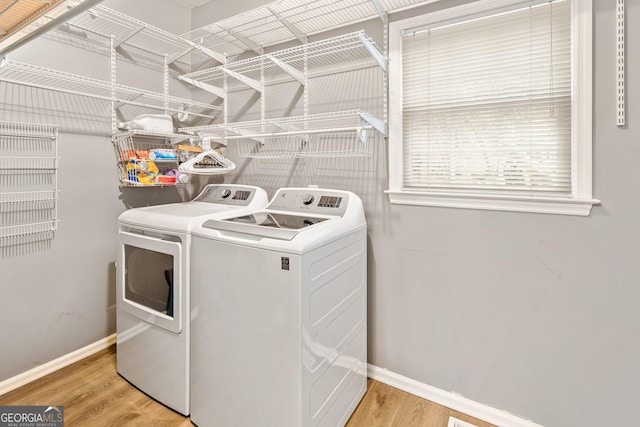 laundry area featuring separate washer and dryer and light wood-type flooring