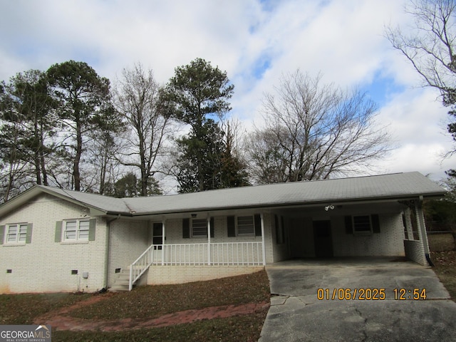 ranch-style home with a porch and a carport