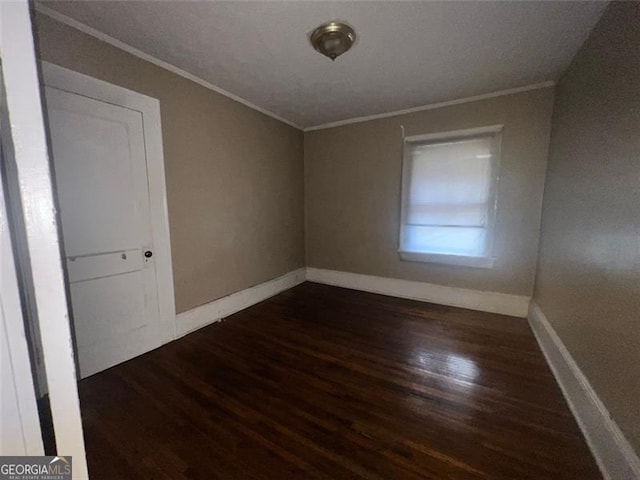 unfurnished room featuring dark hardwood / wood-style flooring and crown molding