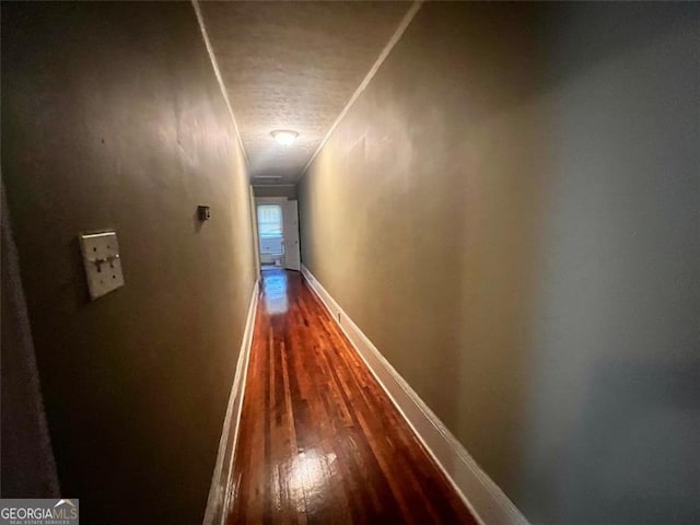 hall featuring crown molding and hardwood / wood-style floors