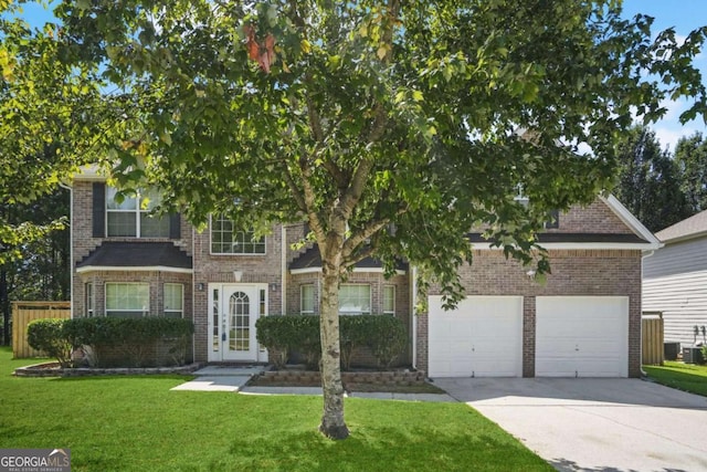 obstructed view of property featuring a garage and a front lawn