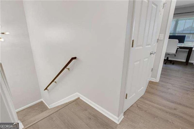 stairway with hardwood / wood-style floors