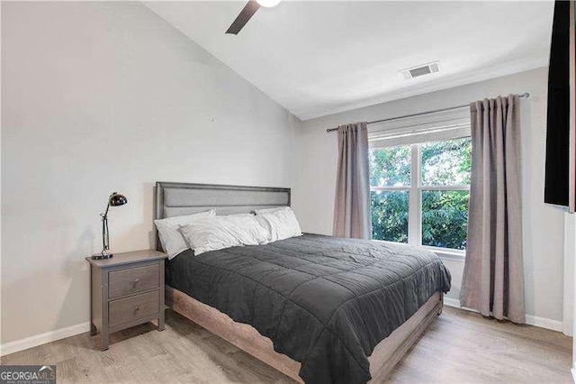 bedroom with light hardwood / wood-style flooring, ceiling fan, and lofted ceiling