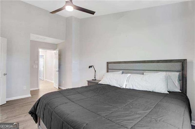 bedroom with ceiling fan and wood-type flooring