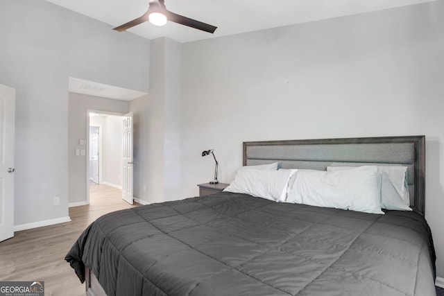 bedroom featuring wood finished floors, visible vents, baseboards, and ceiling fan