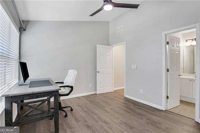 office area with hardwood / wood-style flooring, ceiling fan, and vaulted ceiling