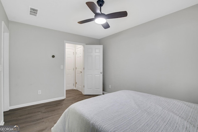 bedroom with dark wood finished floors, baseboards, ceiling fan, and visible vents