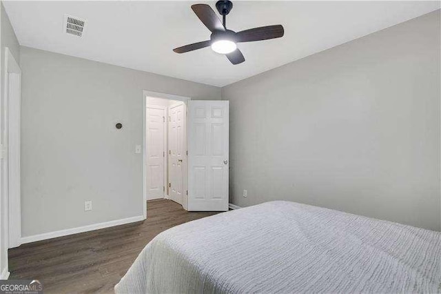 bedroom featuring ceiling fan and dark hardwood / wood-style floors