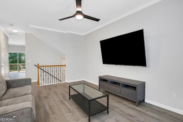 living room featuring baseboards, a ceiling fan, wood finished floors, and ornamental molding