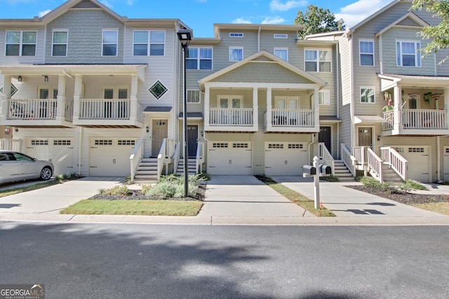 multi unit property featuring driveway, a balcony, and an attached garage