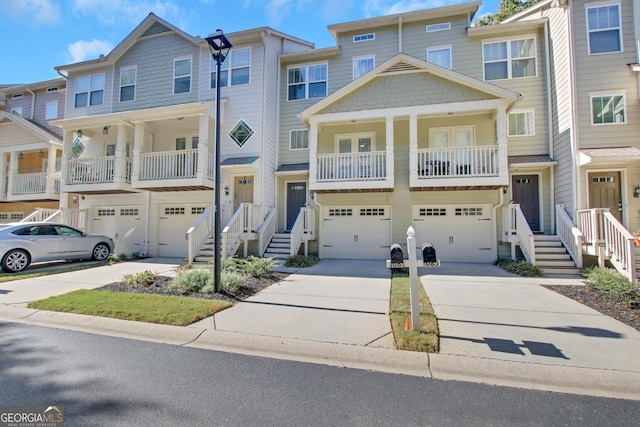 townhome / multi-family property featuring driveway and an attached garage