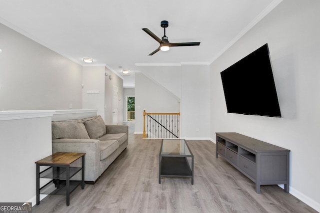 living area featuring wood finished floors, a ceiling fan, and ornamental molding