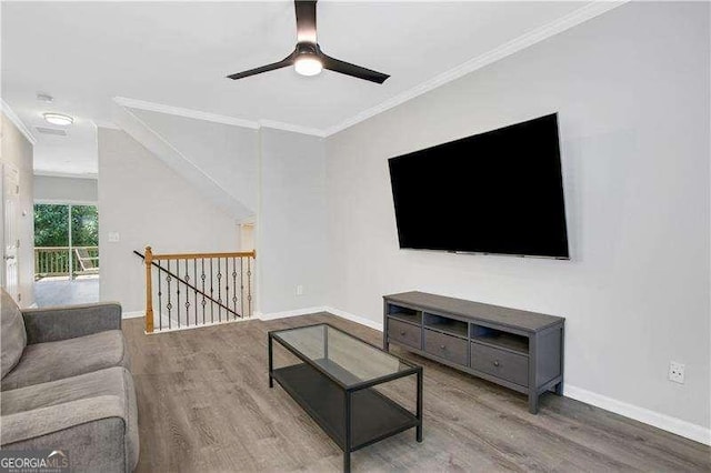 living room with wood-type flooring, ceiling fan, and ornamental molding