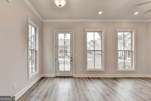 entryway with light hardwood / wood-style flooring, plenty of natural light, ornamental molding, and ceiling fan