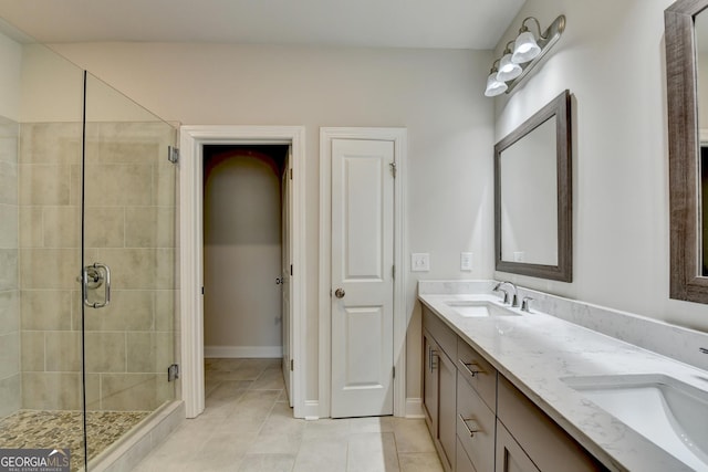 bathroom with tile patterned flooring, vanity, and walk in shower