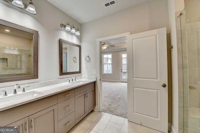 bathroom with tile patterned floors, ceiling fan, tiled shower, and vanity