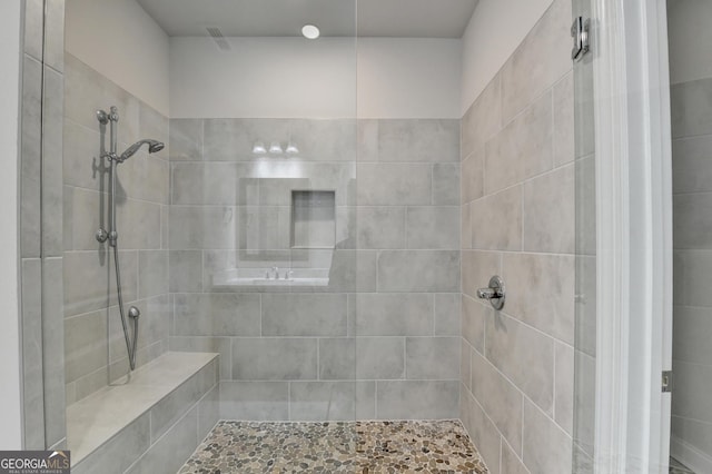 bathroom with tiled shower